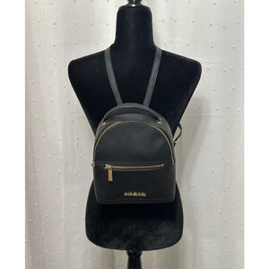 Michael Kors black backpack purse with gold accents.